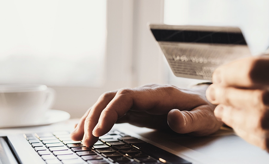 woman with credit card and laptop