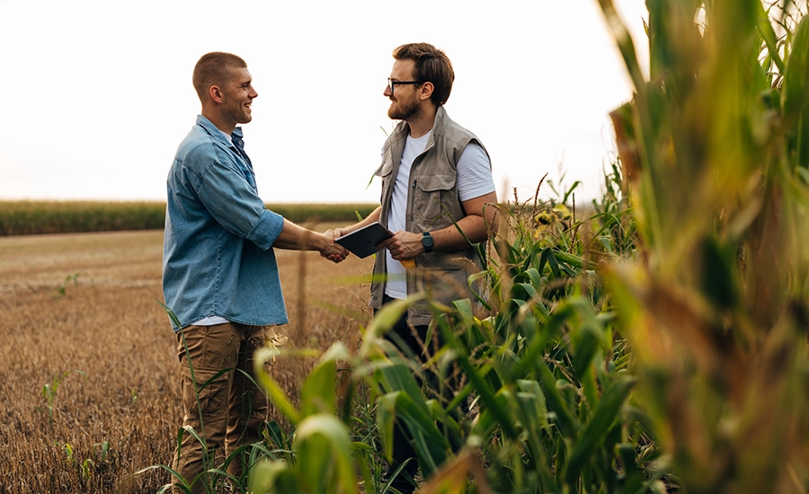 men shaking hands in field
